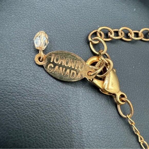 Belladonna Circular Crystal and Gold Tone Infinity Pendant Necklace - Picture 9 of 17